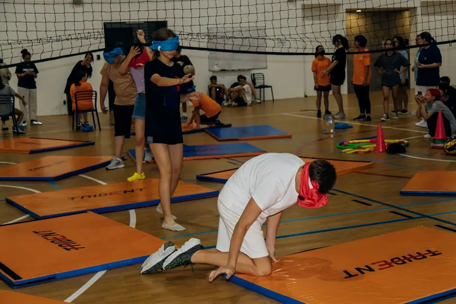 Teenagers in supervised residential summer camp accommodation with a camp leader nearby